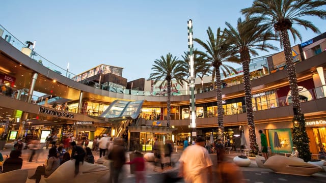 Outdoor shopping mall with people at night outdoors